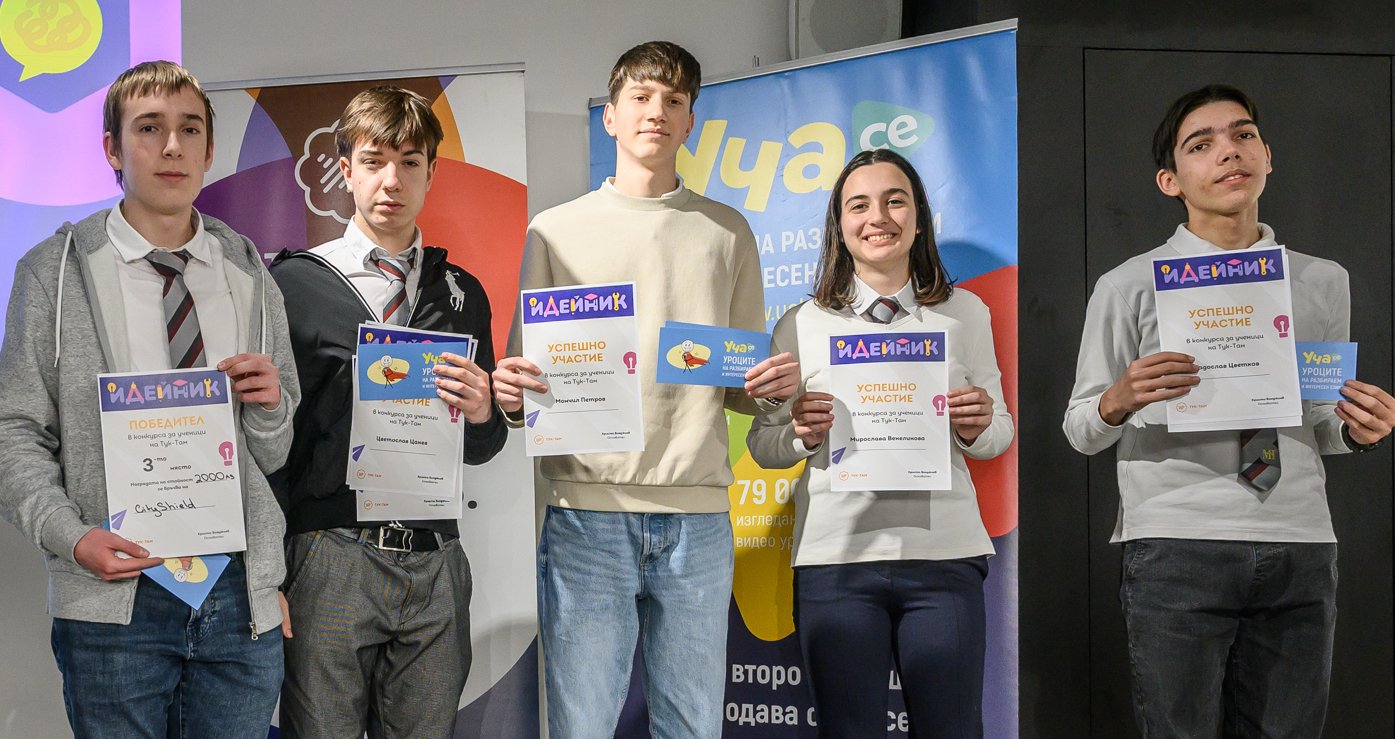 Five young people holding certificates and smiling, standing in front of colorful banner backgrounds.